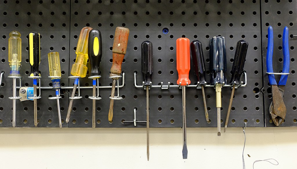 screwdrivers in a rack on a pegboard